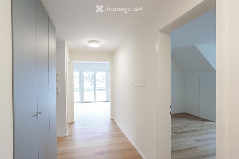 Hallway with wooden floors, sliding glass doors, and two open doors leading to rooms