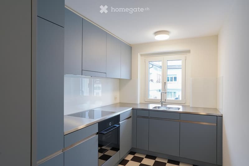 modern kitchen, gray cabinets, stainless steel countertops, integrated stove, oven, modern sink, windows