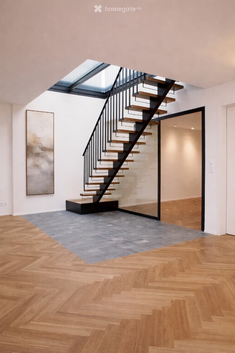 modern interior, wooden floor, white walls, black metal staircase, glass wall, skylight