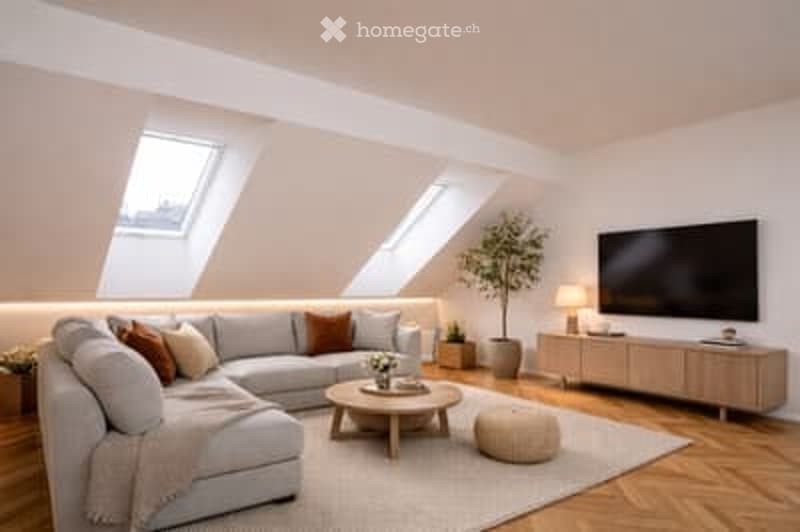 Modern living room with large windows, grey sectional sofa, coffee table, ottoman, floor lamp, TV, sideboard, and potted plant.