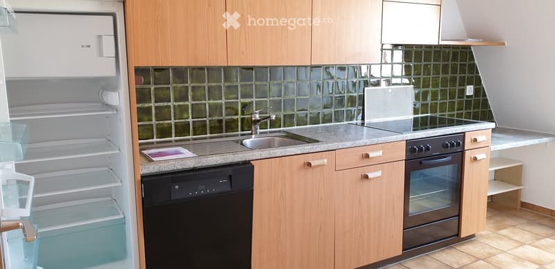 Modern kitchen with light wooden cabinets, granite countertop, stainless steel sink, and appliances including a refrigerator, oven, and dishwasher.