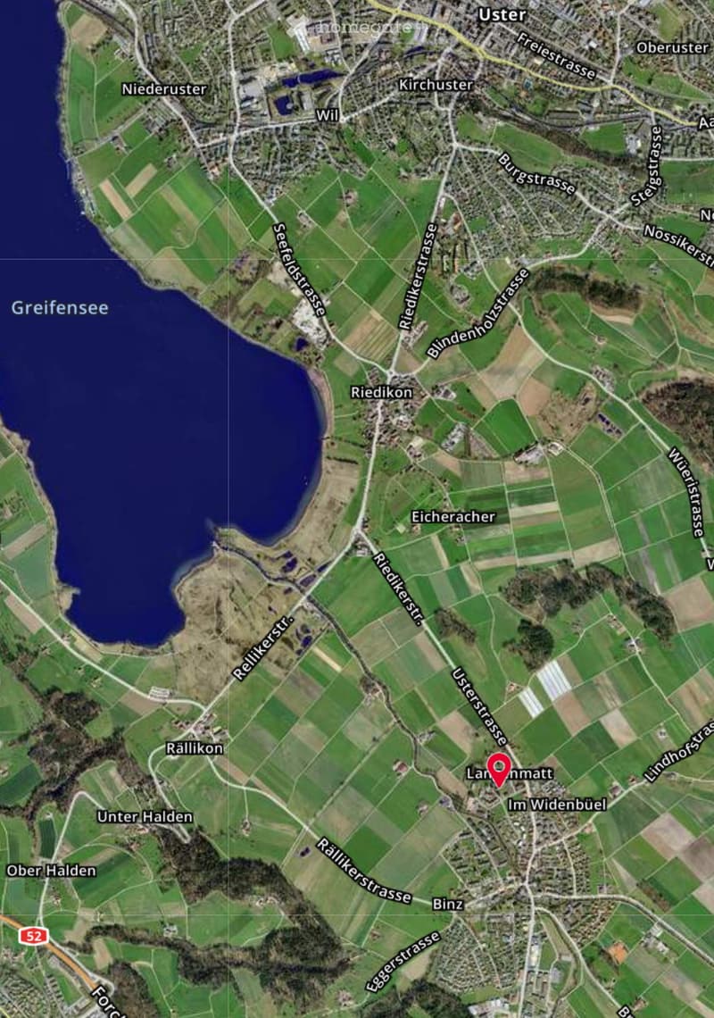 Aerial view of a rural area with fields, roads, and a lake named Greifensee. The map shows various labeled locations and streets.