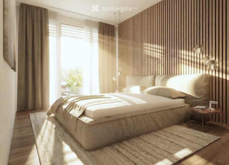 A bedroom with a large bed, wooden floor, wooden wall, large window, curtains, rug, nightstand, and lamps