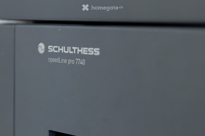 Close-up of a grey Schulthess speedLine pro 7740 appliance, likely a washing machine or dryer, with branding and model name visible.