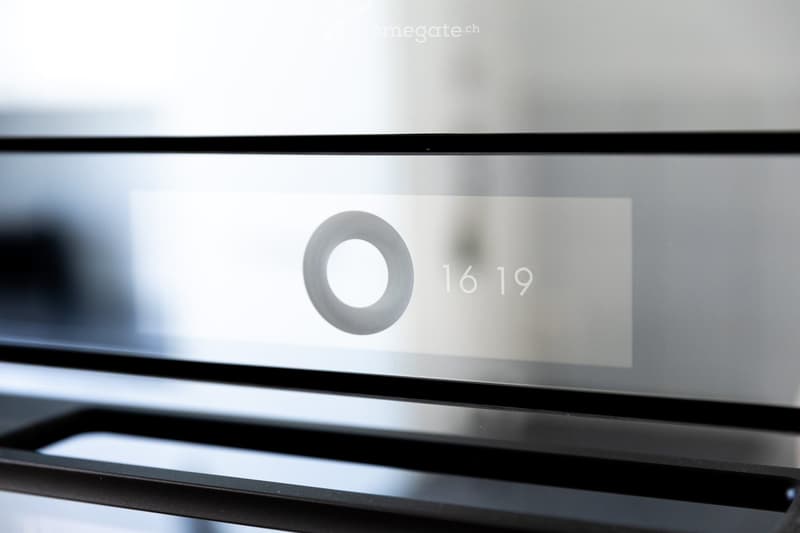 A sleek, modern television screen displaying a logo and the number 1619, mounted on a black stand.