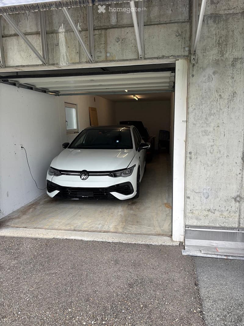 {"visible_features": ["Garage", "Parking place"], "type": "Garage", "objects": [], "description": "Garage with a white Volkswagen car parked inside, concrete walls and ceiling, open garage door.", "localized_descriptions": {"EN": "Garage with a white Volk