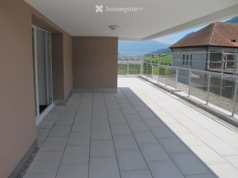 Balcony with tiled floor, metal railing, and scenic mountain view.