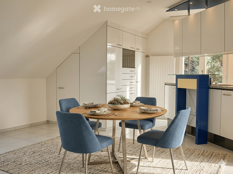 round dining table, blue chairs, carpet, white kitchen, shelves, window