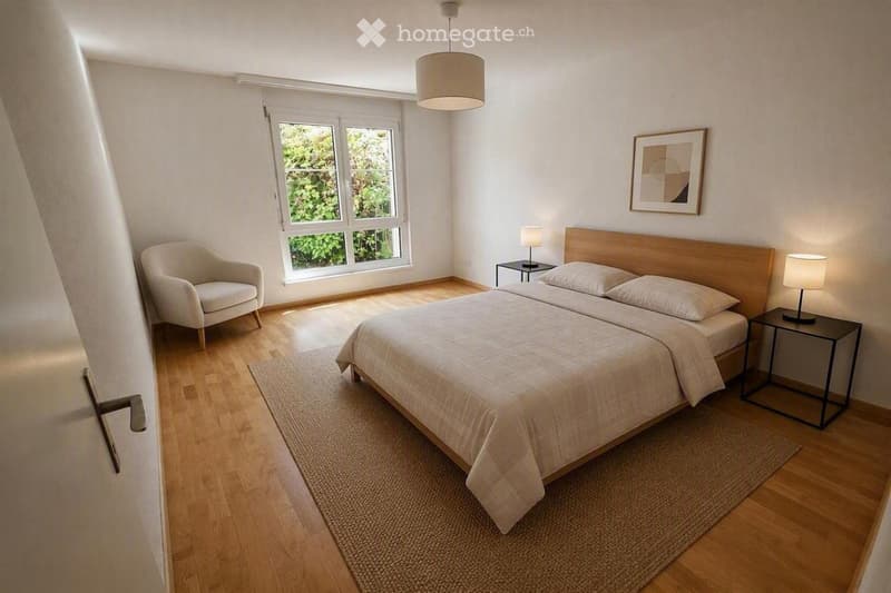 Bright bedroom with wooden flooring, a double bed with white bedding, a nightstand with a lamp, a small armchair, and a large window with a view of greenery.