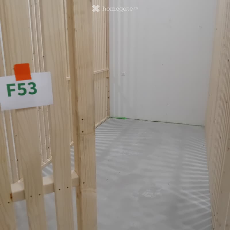 Empty room with wooden framing and a concrete floor, marked with a sign reading "F53".