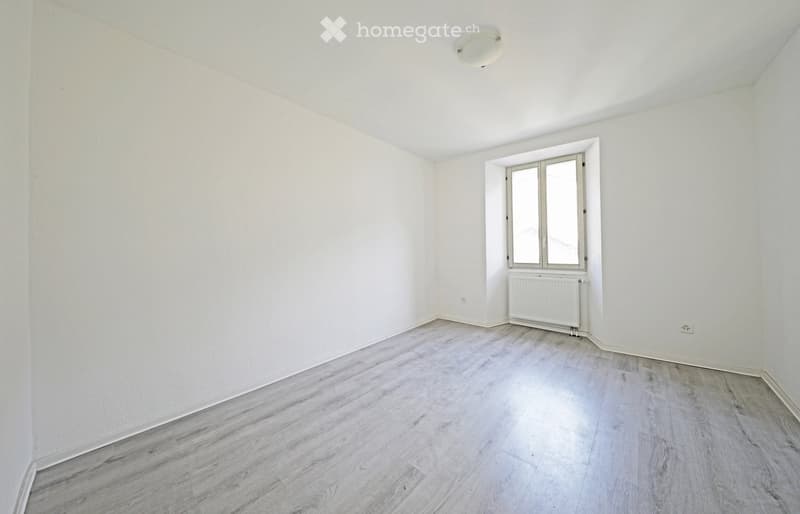 empty room, white walls, wooden floor, window, radiator