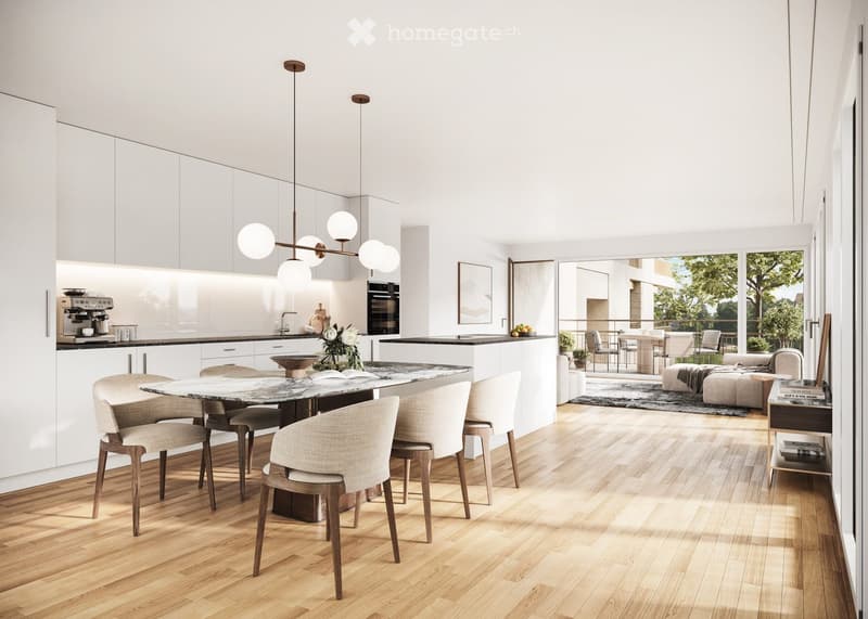 Open-plan kitchen and living area with white cabinetry, a central dining table with six chairs, a coffee maker, an oven, and a pendant light. The living area features a sofa, ottoman, side table, and books, with large windows and a balcony view.
