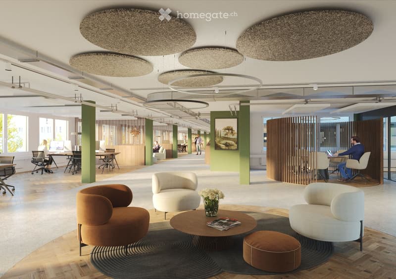 Modern office lounge area with comfortable seating, a coffee table, and large windows letting in natural light.