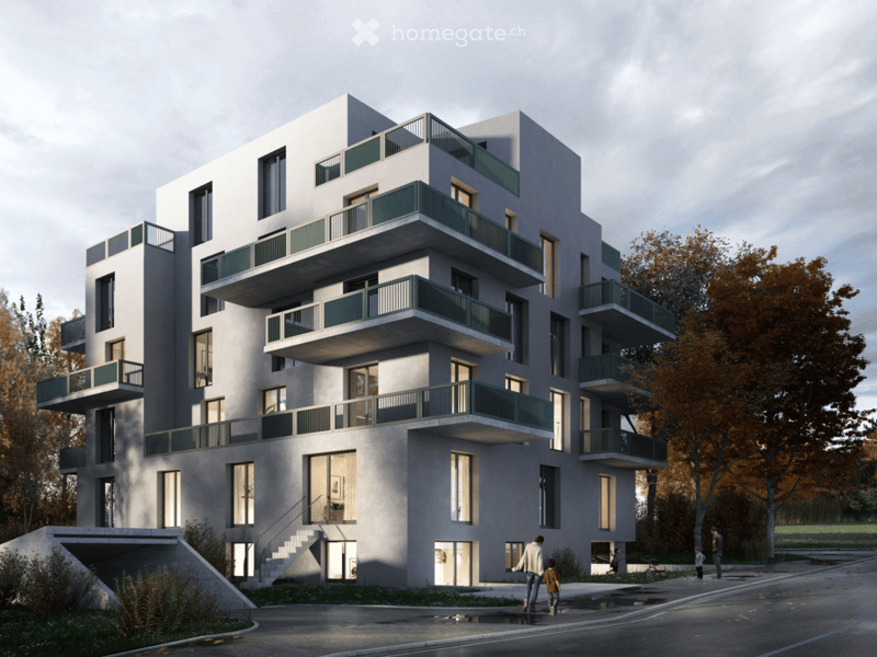Modern multi-story residential building with balconies, large windows, and contemporary design. The building features a clean, minimalist facade with green railings on the balconies.