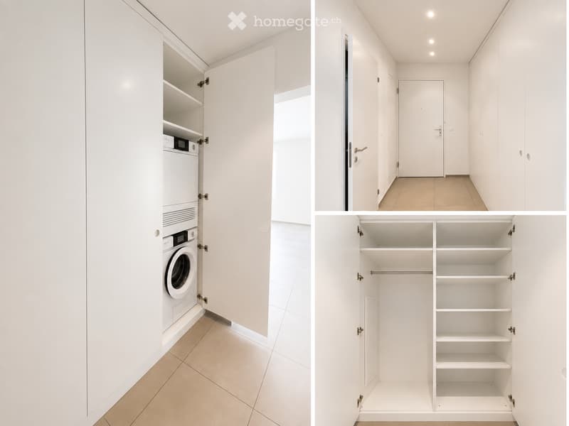 A clean, unfurnished room with white walls, tiled flooring, and built-in storage cabinets. The room includes a washing machine and a closet with multiple shelves and hanging space.
