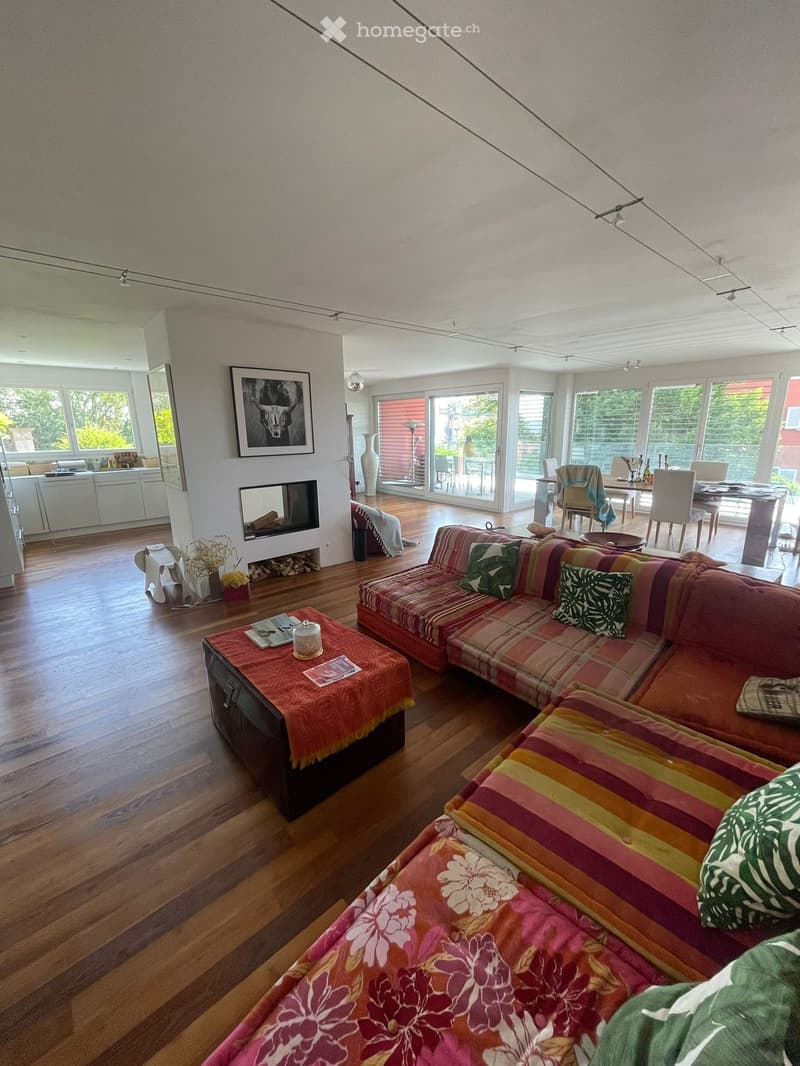 large wooden floor, modern design, fireplace, dining table, kitchen, multiple large windows