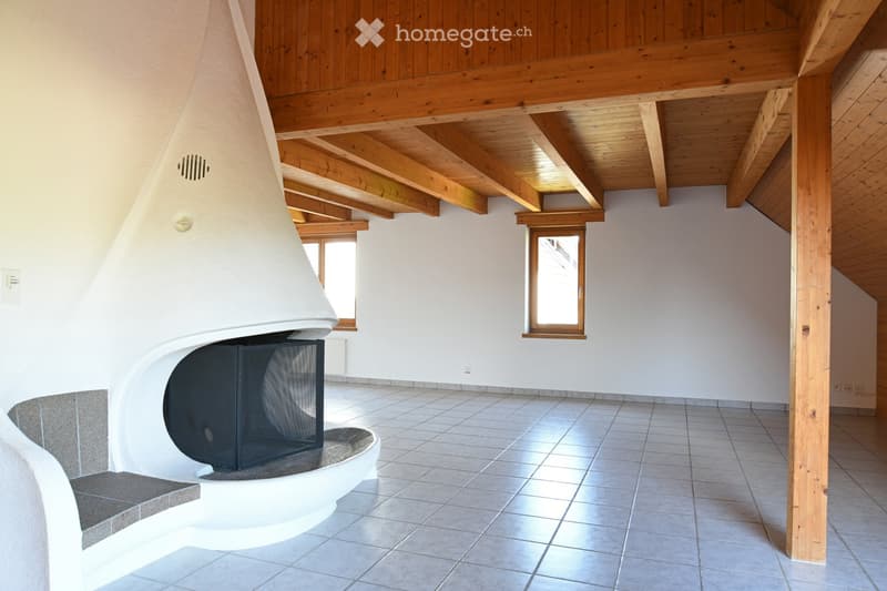 An unfurnished room with a modern fireplace, exposed wooden beams, tiled floor, and two windows.