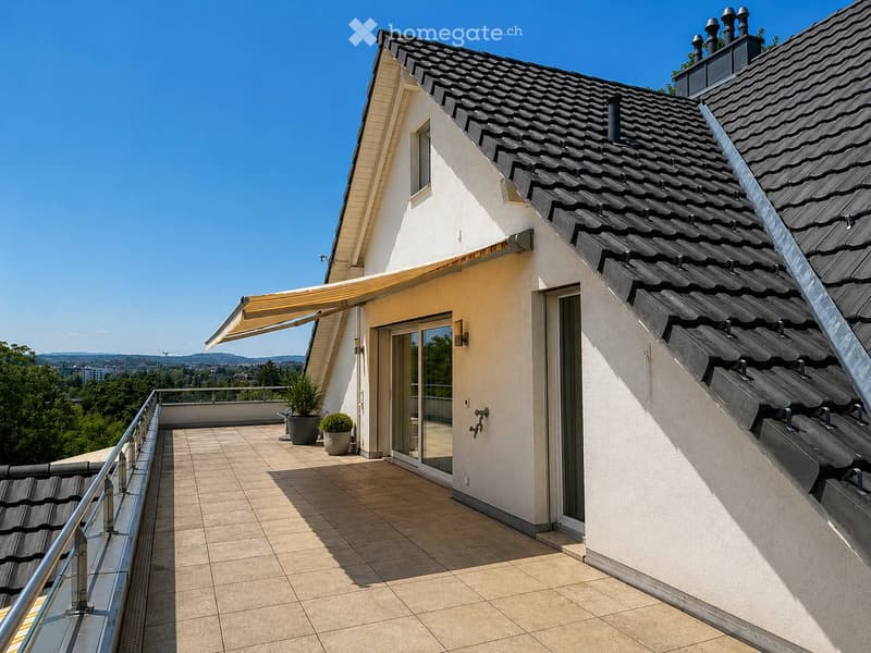Balcony with tiled floor, glass railing, potted plants, sliding glass door, and extended awning.