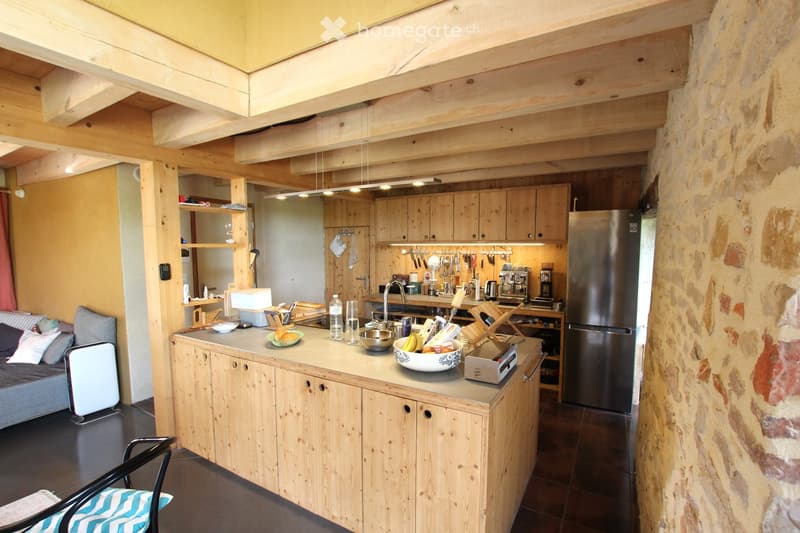 {"type": "Furnished Room", "objects": ["sofa", "chair", "refrigerator", "kitchen island", "faucet", "coffee maker", "oven", "cupboard", "fridge", "bowl", "faucet", "cupboard", "fridge", "oven", "cupboard", "cupboard", "cupboard", "cupboard", "cupboard", "