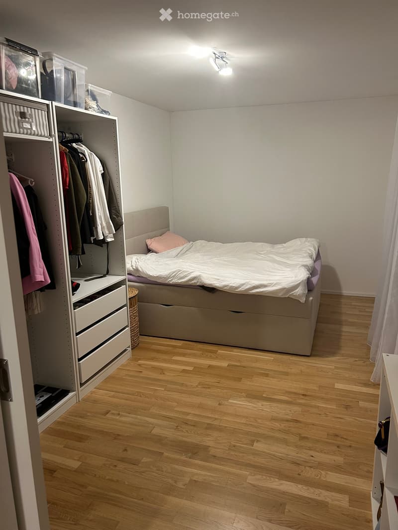 room with bed and wardrobe, wooden floor