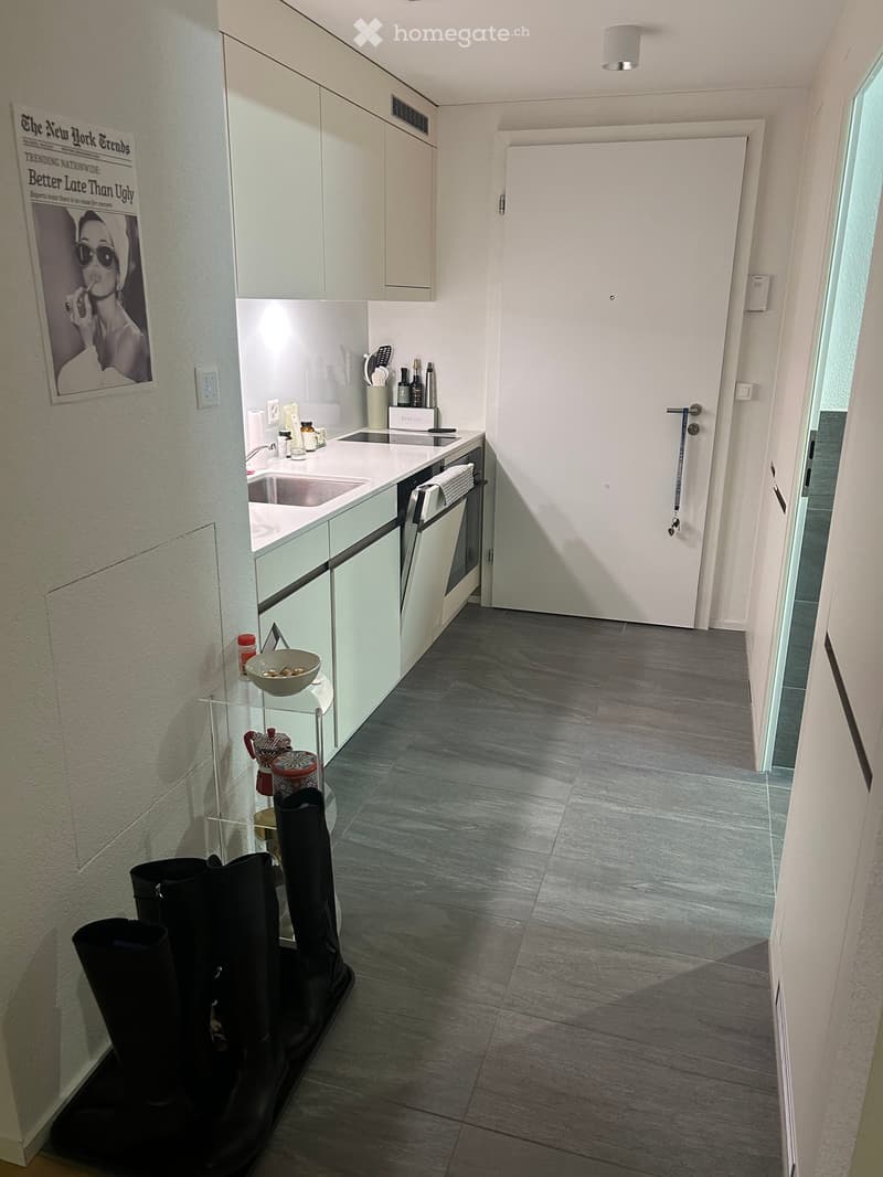 modern kitchen with granite countertop, stainless steel appliances, white cabinets, tiled flooring