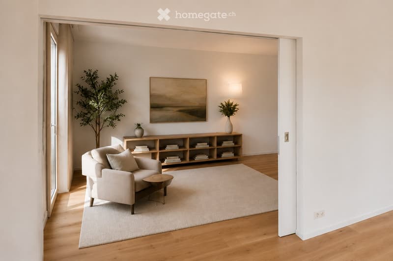 Modern living room with light-colored furniture, a sofa, coffee table, bookshelf, and decorative vases.