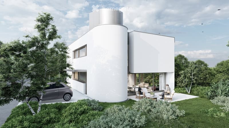 Modern two-story house with white exterior, cylindrical tower, large windows, and a raised ground floor. Includes a small outdoor seating area with chairs and a table, surrounded by greenery and a parked car.