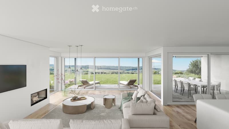 Modern living room with large windows offering a scenic view, featuring a sofa, coffee table, fireplace, and a dining area visible through the open sliding doors.