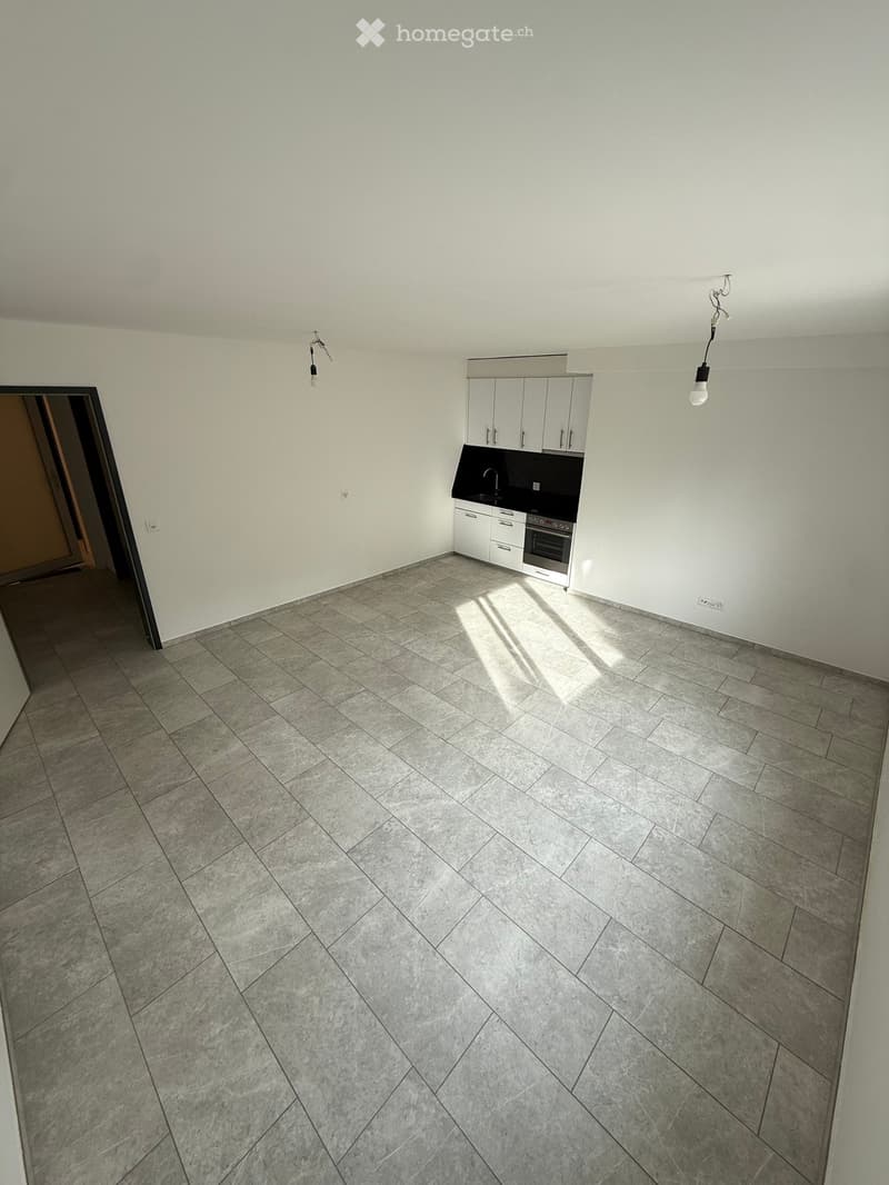 empty room, white tiled floor, modern white cabinetry, countertop, oven