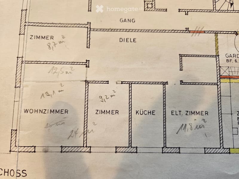 Floor plan showing a living room, kitchen, two bedrooms, hallway, and garden area with dimensions labeled in meters.