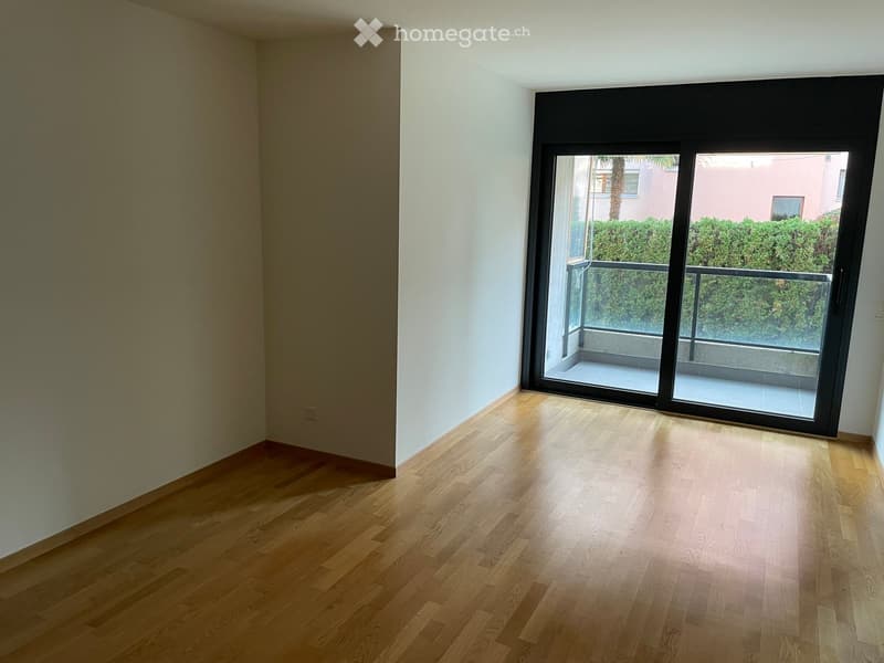 empty room, wooden floor, white walls, sliding glass door, balcony