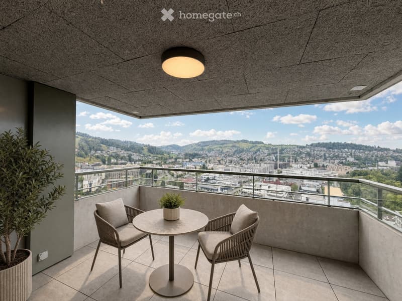 Modern balcony with round table, two chairs, potted plants, and expansive city view.