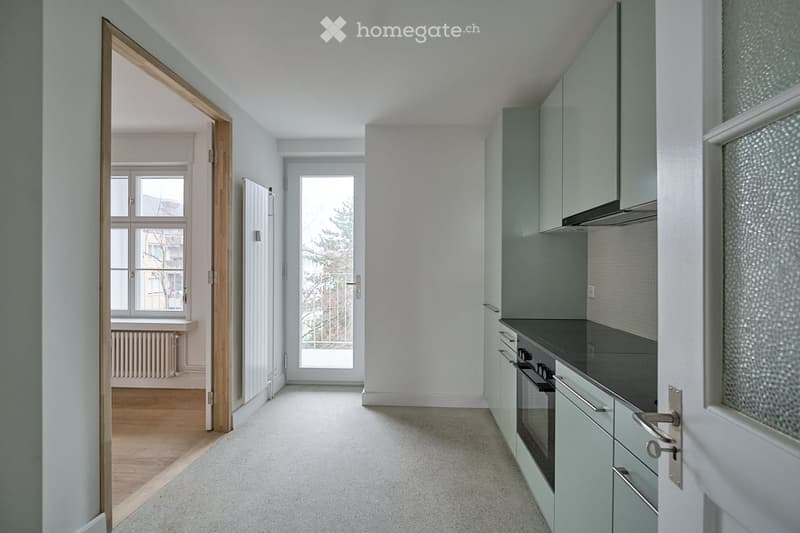 modern design kitchen, granite countertop, built-in oven, white walls, wooden floors, large windows