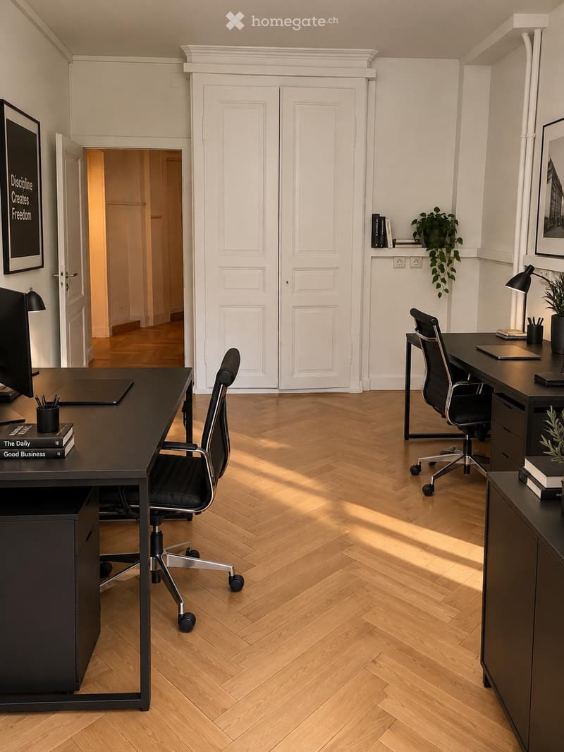 Modern office space with herringbone wooden flooring, two desks, office chairs, computer screens, lamps, and decorative plants.