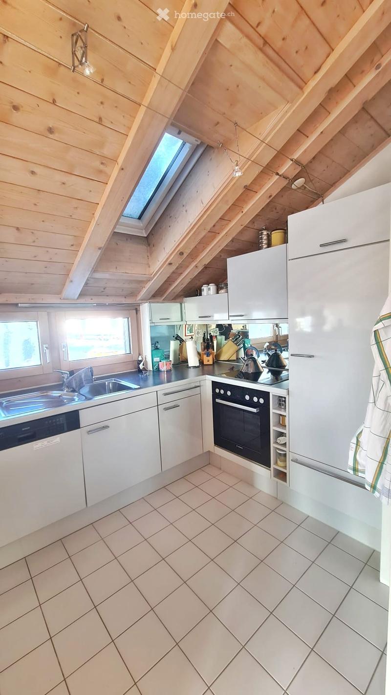 Modern kitchen with white cabinets, stainless steel appliances, and a tiled floor. Features include a refrigerator, oven, dishwasher, sink, and various kitchen utensils.