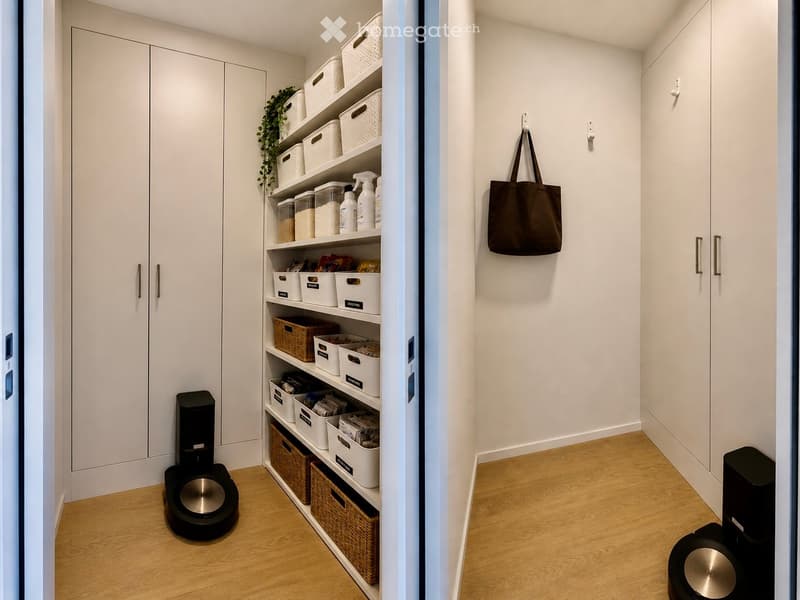 A modern, well-organized hallway with white walls, light wooden flooring, built-in storage shelves, and a hanging handbag. Two robotic vacuums are visible on the floor.