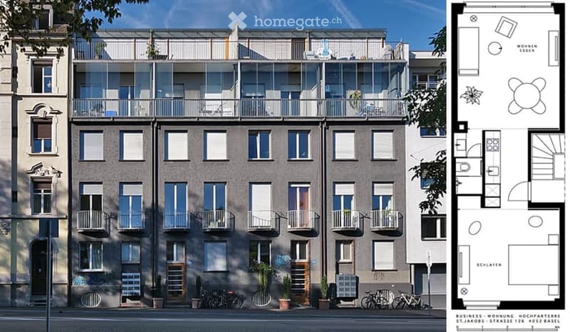 Modern multi-story apartment building with balconies, large windows, and bicycles parked in front.