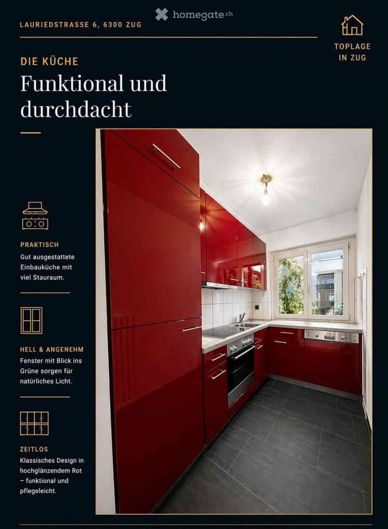 Modern kitchen with red cabinets, stainless steel appliances, and large windows providing natural light.