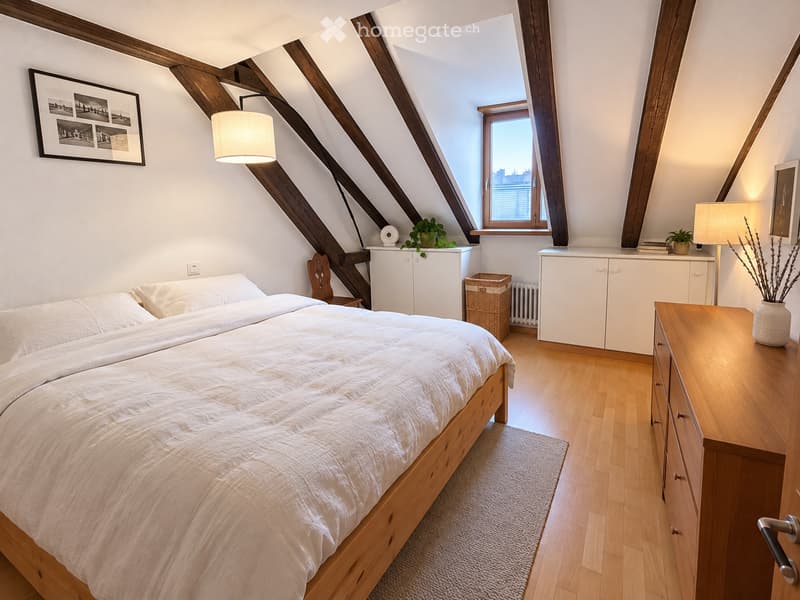Cozy attic bedroom with wooden slanted ceilings, a large bed with white bedding, a nightstand, a wooden cabinet, a wicker basket, and decorative plants.