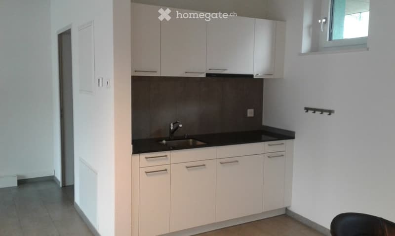 Small kitchen, white cabinets, dark countertop, sink, faucet, black and white tiles, small window