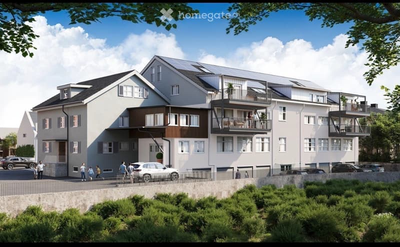 Modern multi-story residential building with balconies, solar panels, and parking area.