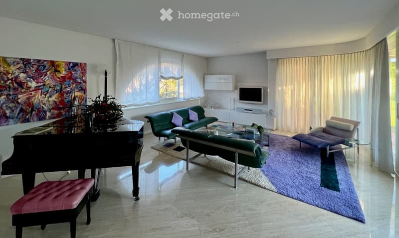 Modern living room with a green sofa, coffee table, piano, and large windows with curtains.