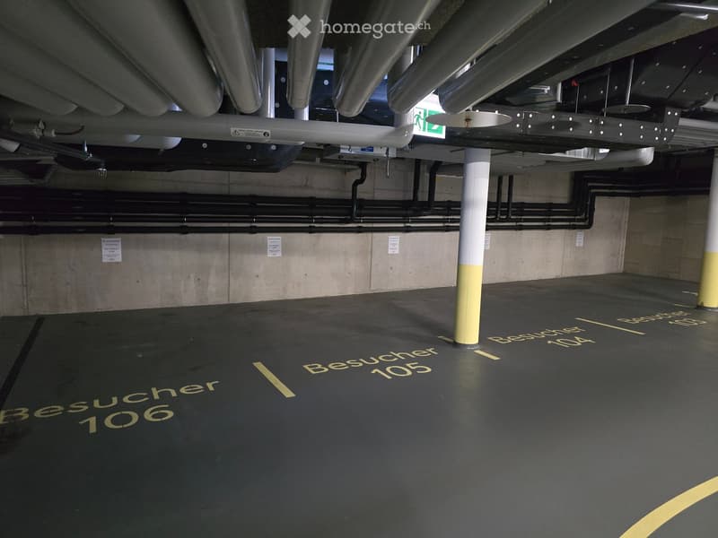 {"type": "Parking place", "objects": [], "description": "Underground parking area with marked visitor parking spaces labeled 'Besucher 106' and 'Besucher 104', concrete pillars, and visible ventilation ducts.", "localized_descriptions": {"EN": "Undergroun