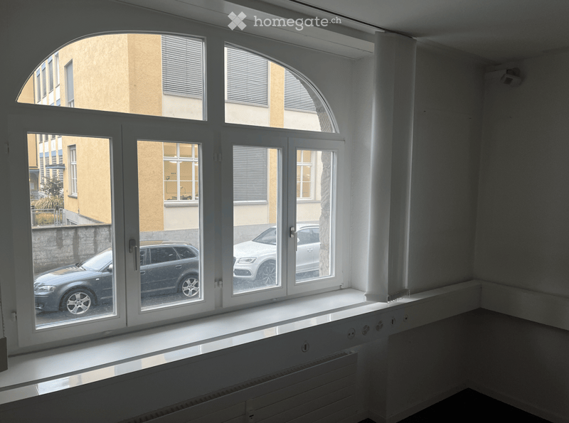 room with large window, white walls, white windows, white radiators, no furniture