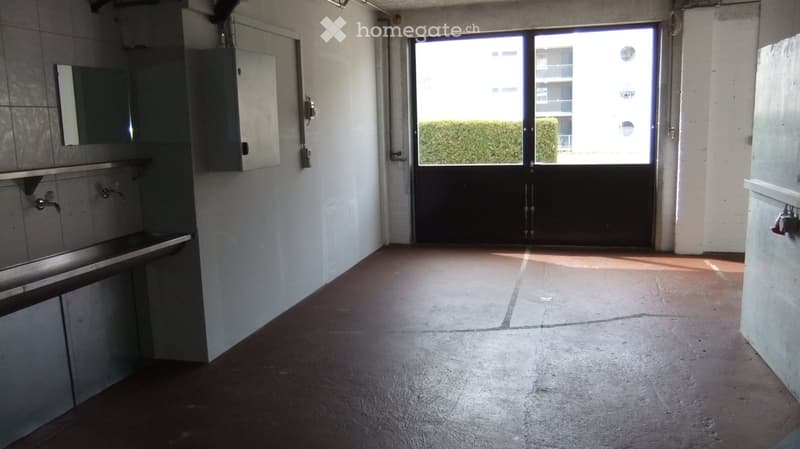 Empty room with a sink, mirror, and a large sliding door leading to a balcony or outdoor area.
