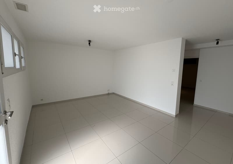 Empty room with white walls, tiled floor, and a window on one side. No furniture or equipment is present.