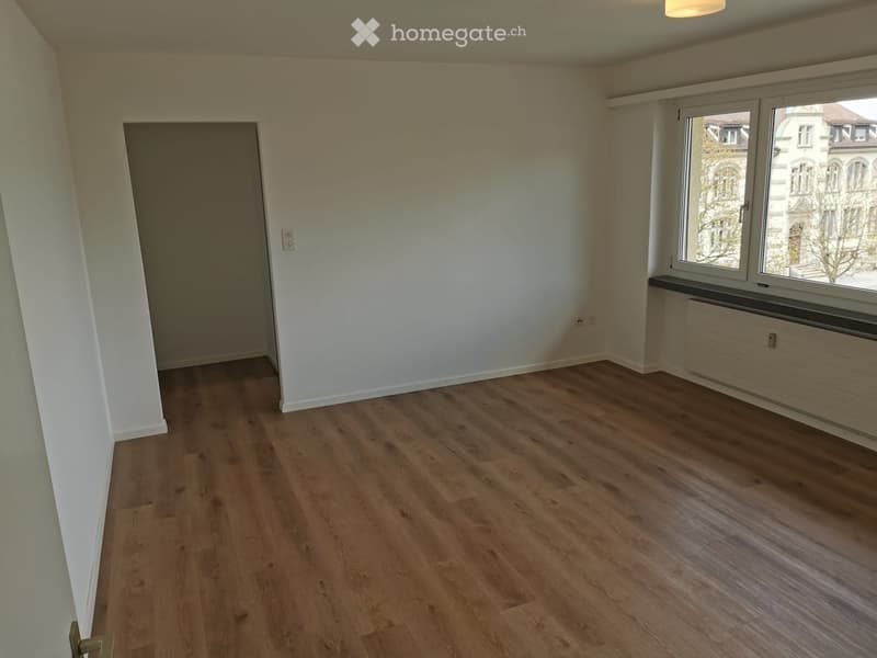 empty room, white walls, wooden floor, large window with city view