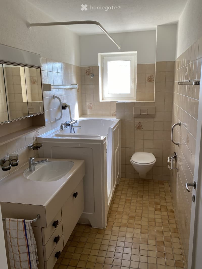 Bathroom with bathtub, sink, toilet, mirror, and towel rack