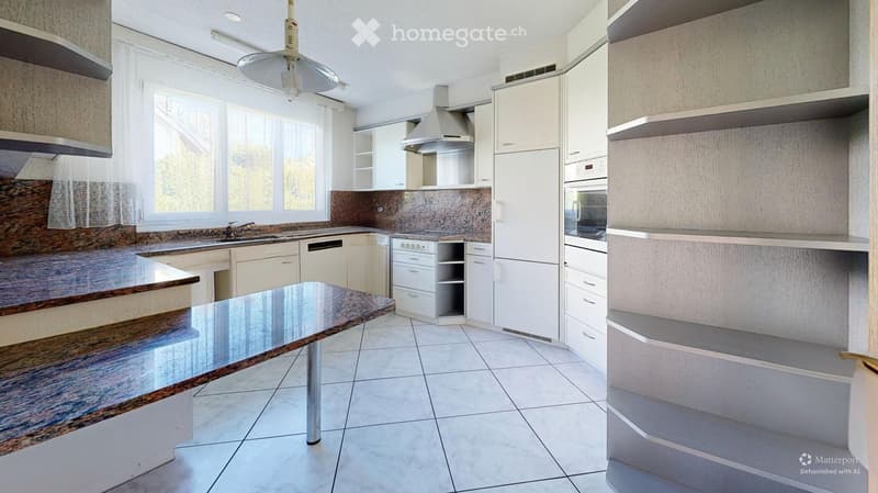 Modern kitchen with white cabinets, stainless steel appliances, granite countertops, and a central island with a glass table.