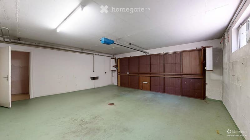 Empty room with white walls, green flooring, and a wooden cabinet. No furniture or equipment present.